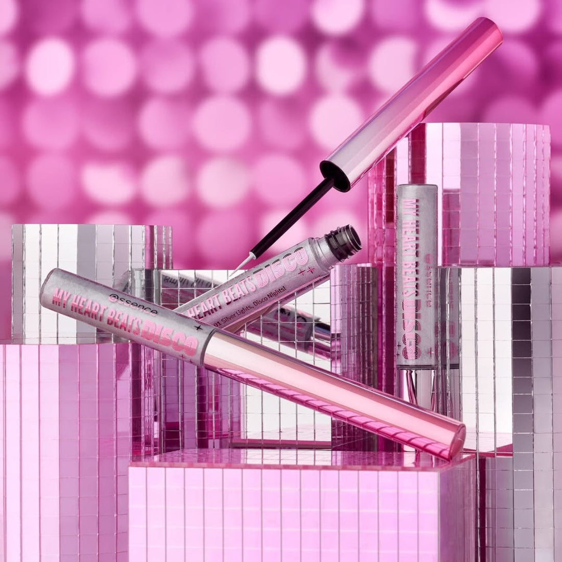Pink makeup products with a blurred pink background